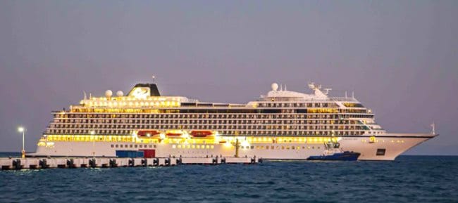 A cruise ship lit at dusk alongside the pier at Kuşadası port, the gateway to Ephesus