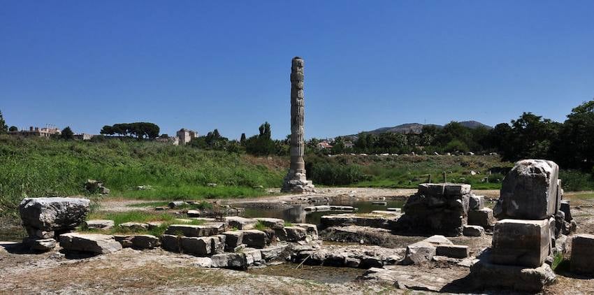 A single re-erected column standing among the flooded stone foundations of the Temple of Artemis at Selçuk