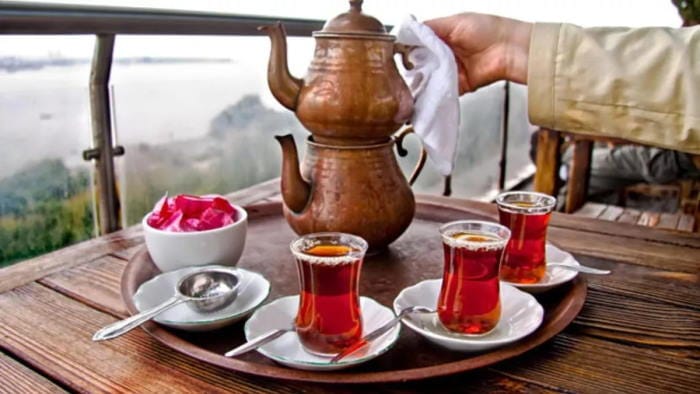Turkish tea served in tulip-shaped glasses with a teapot
