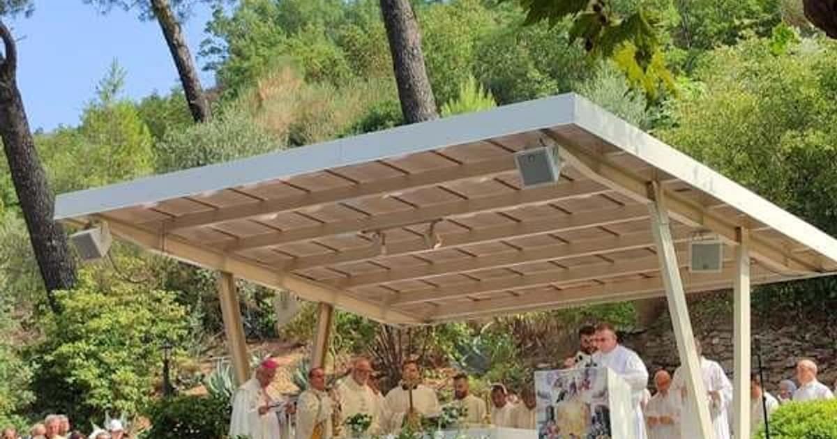 Clergy in white vestments celebrating an open-air Mass under a canopy on the terrace at the House of the Virgin Mary